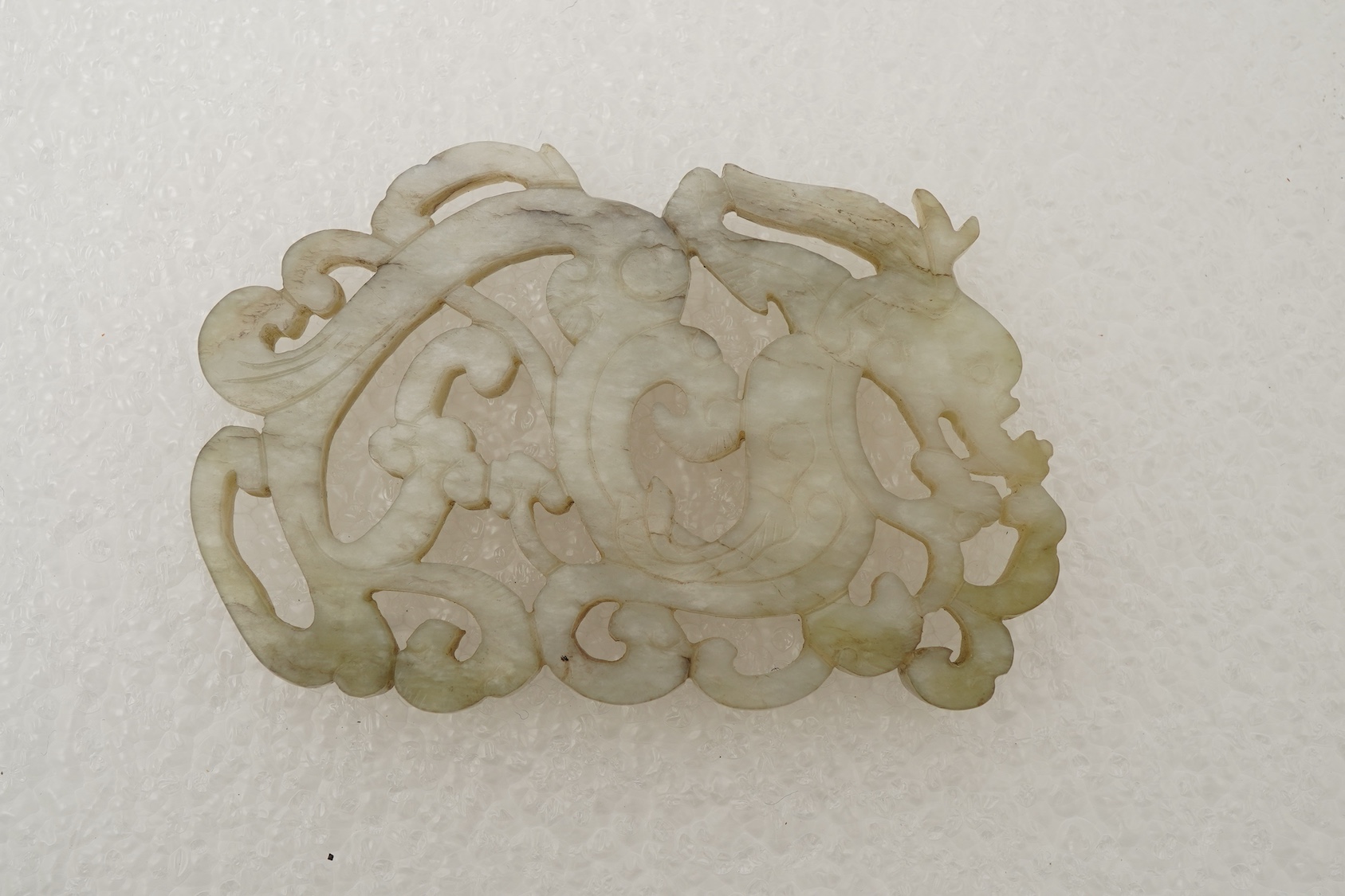 A Chinese white and grey mottled jade ‘chilong’ plaque, Ming dynasty